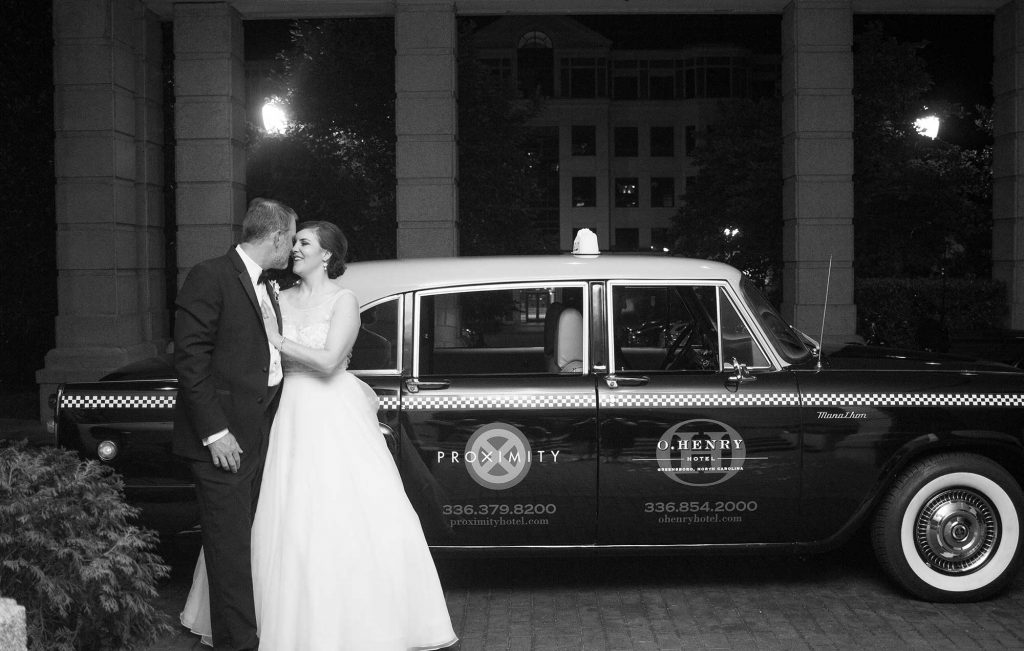 Weddings at O.Henry Hotel with Stephanie and Tim's pose for a London Taxi Departure