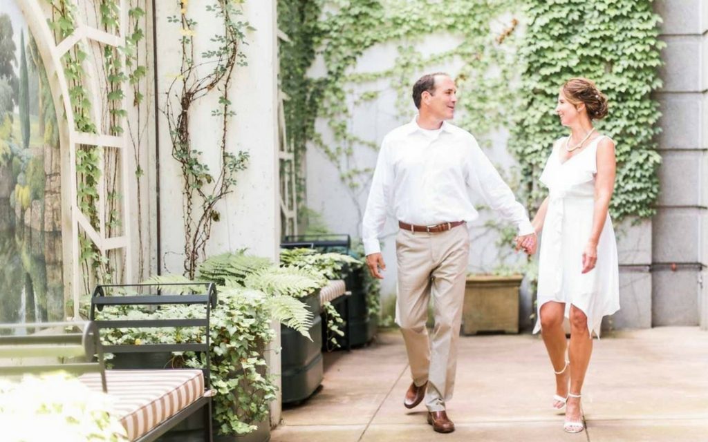 The bride and groom in the English-Inspired Walled garden at O.Henry Hotel