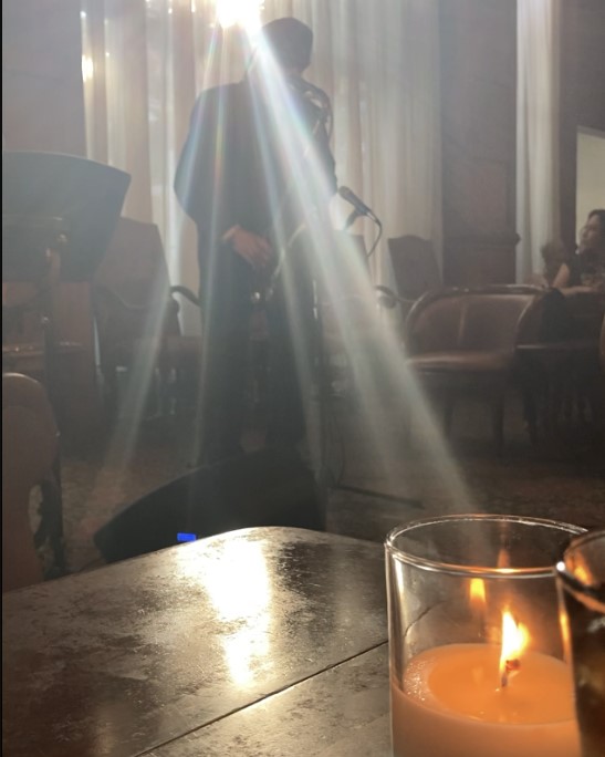 Neill Clegg Jr plays the Saxophone in a sunny social lobby