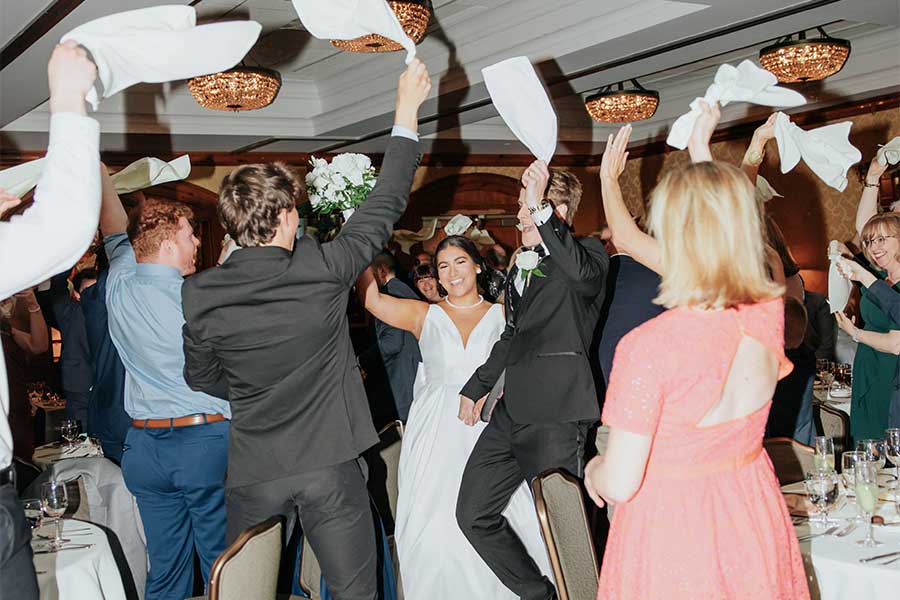 Guests erupted in cheers as Sarah and Kyle entered the reception to “Gimme Gimme” by ABBA, waving napkins in celebration.
