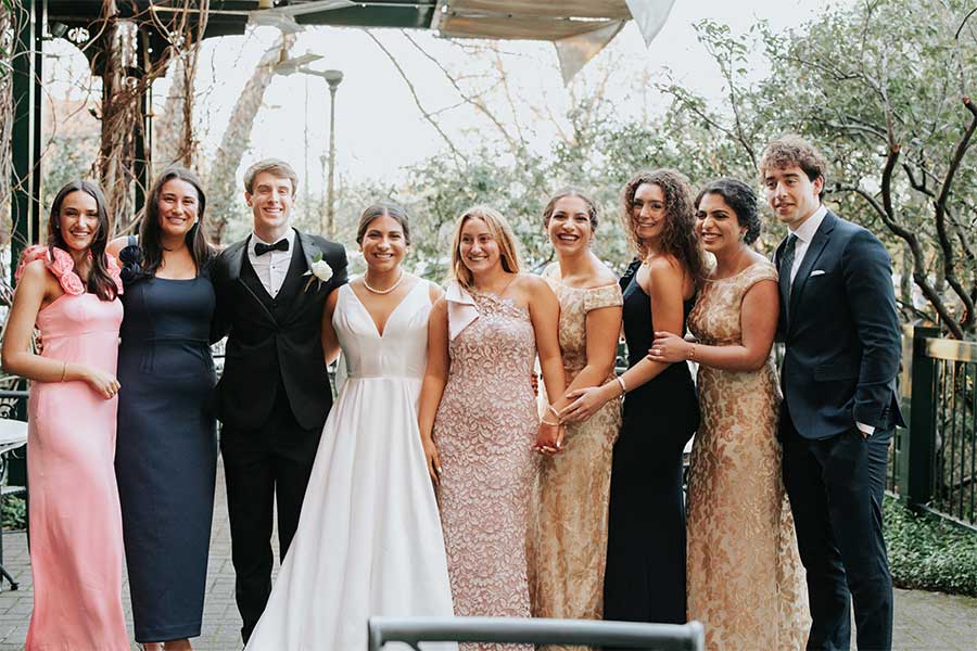 The wedding party takes a photo in the Courtyard. The Caldwell Room features a large arched door that opens to an intimate courtyard.
