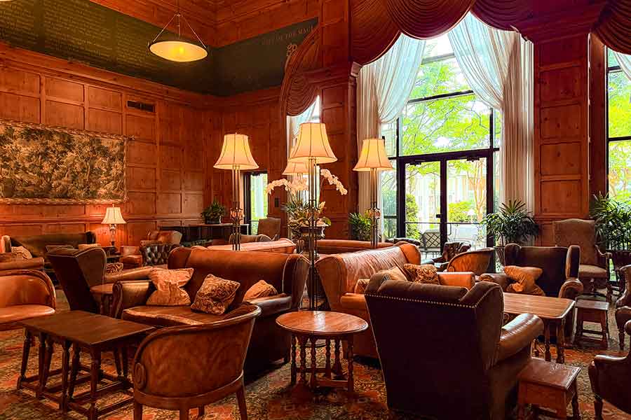 O.Henry Hotel Social Lobby - Guests find our social lobby both grand and irresistibly inviting. With its 25-foot high ceiling and 25-foot wide arched window looking onto our cloister garden, the social lobby’s custom-designed William Alan furniture and authentic British joint stools.