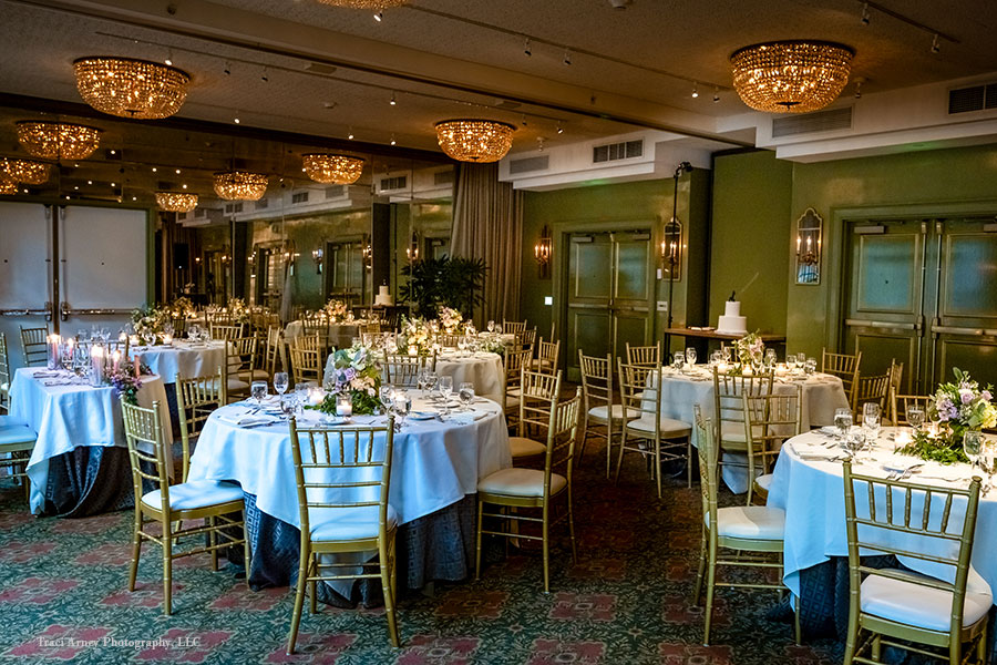 Wedding reception elegantly decorated in white, lavender, and with neutral tones.