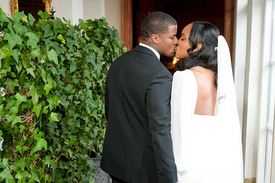 Latisha and Ronald, married at O.Henry Hotel—walk hand in hand down the mirrored hallway