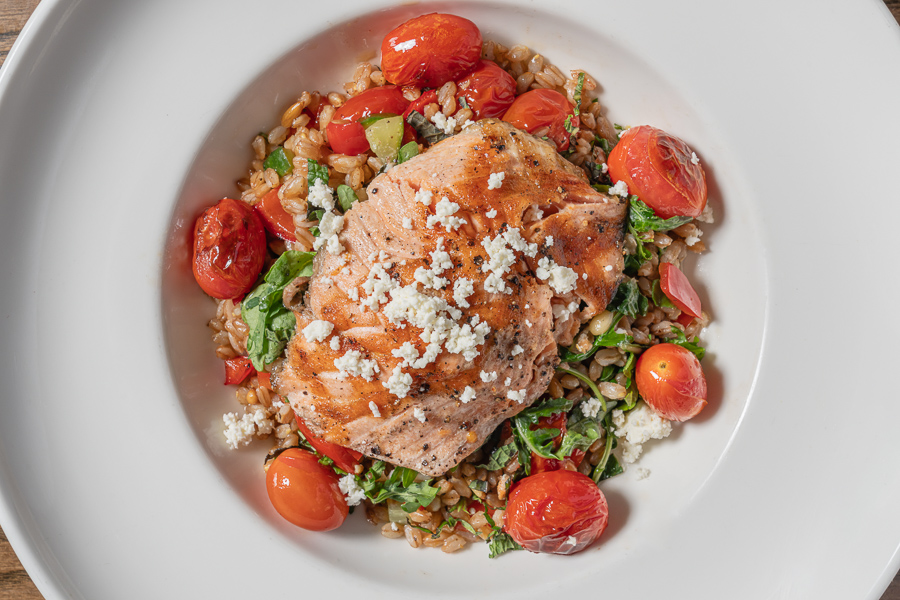 Warm Farro Salmon Salad, cherry tomatoes, cucumber, red bell pepper mint, pine nuts, garden rocket, feta, garlic-oregano vinaigrette